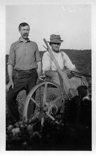Two Men with Farm Machinery 
