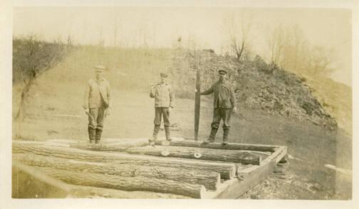 Men with Logs and Saw 
