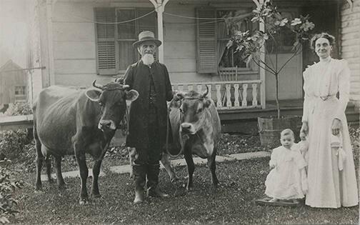 Family posed with Dairy Cows