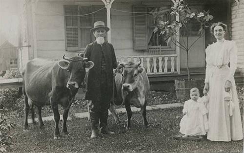 Family posed with Dairy Cows