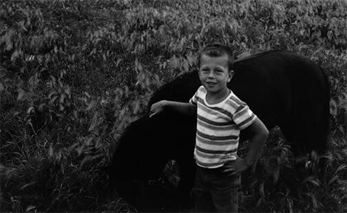 Boy in Pasture with a Pony