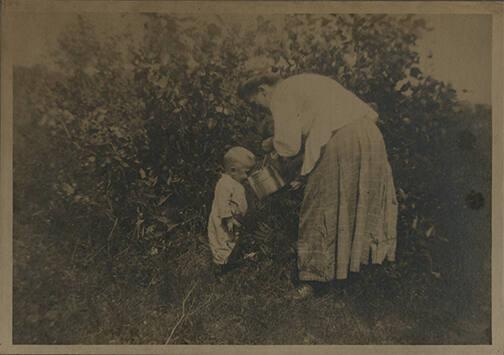 Toddler Drinking from a Small Pail