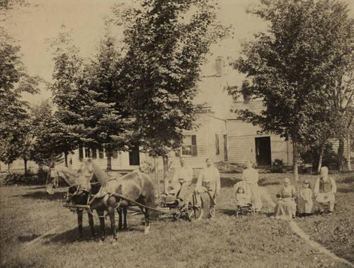 Figures in Front of a House