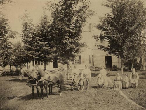 Figures in Front of a House