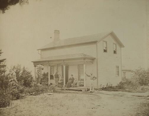 Figures on Porch of House