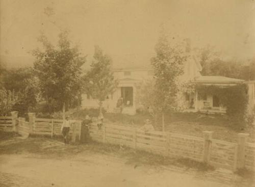 Family Posing Outside of House