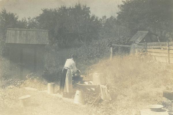 Woman Washing in Outdoor Sink at Duroe-Dell Farm