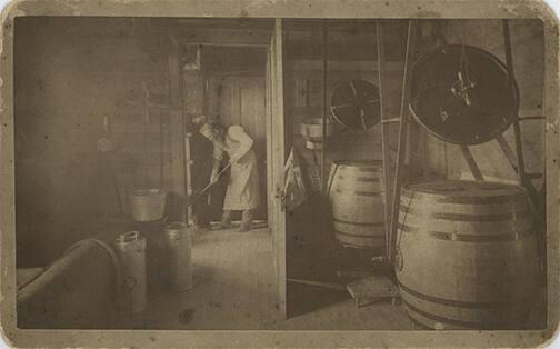 Man Cleaning a Dairy House