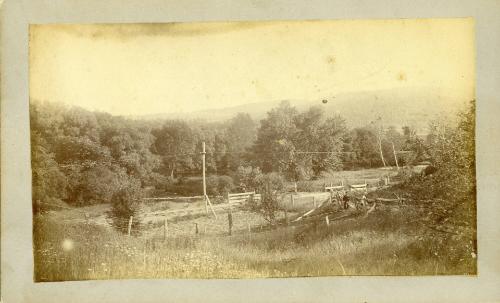 Two Men in a Field by Train Tracks