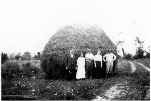Five People in Front of a Haystack