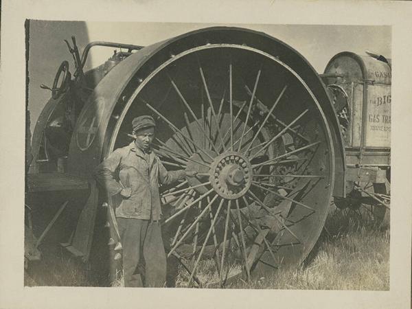 Man Standing near Big Four Tractor