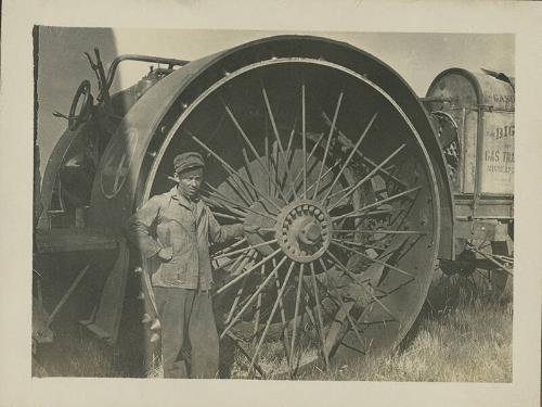 Man Standing near Big Four Tractor