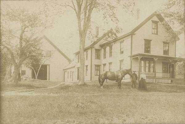 Couple with Horse in Front of Farmhouse