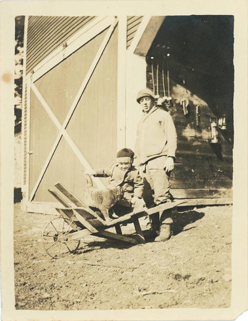 Child and Cat on Wheelbarrow