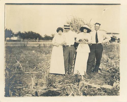 Two Couples in a Harvested Corn Field