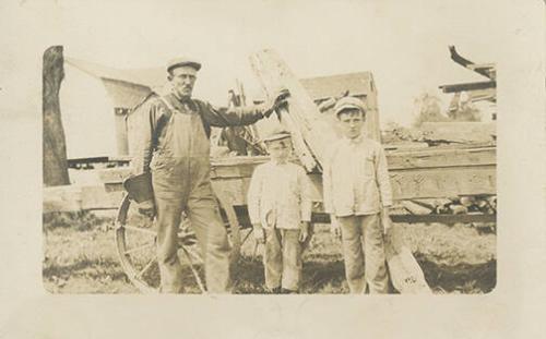 Man and Boys in Front of Wagon