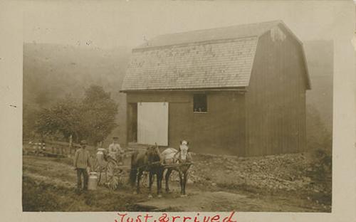 Two Men and Two Horses in Front of Barn