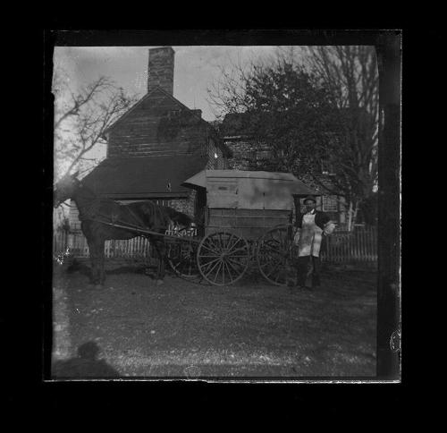Man Stands Selling Near Wagon