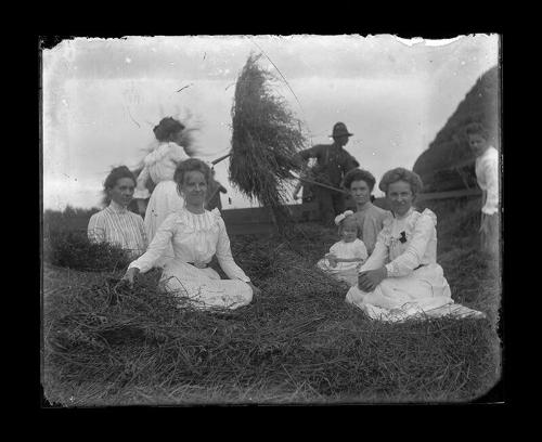 Young Girls Sit Among Moving Hay