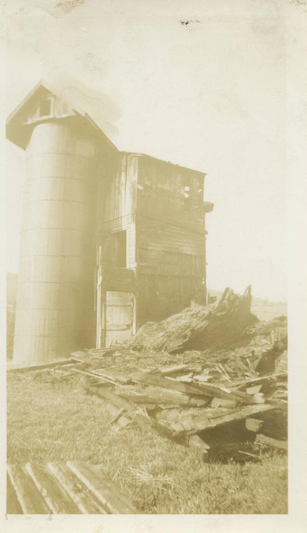 Large Silo With a Stack of Loose Hay