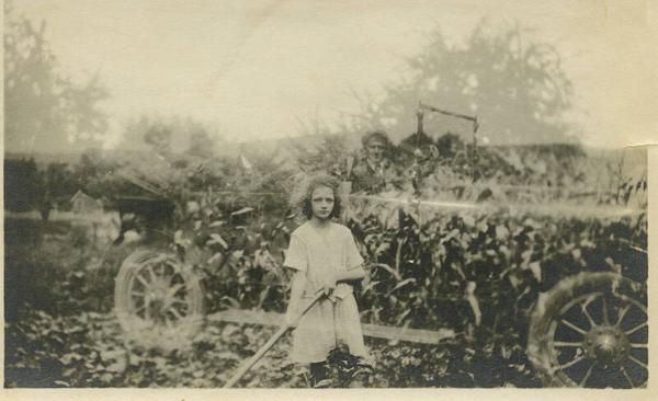 Double Exposure of Girl In Front of Corn and Man Sitting In Car Behind