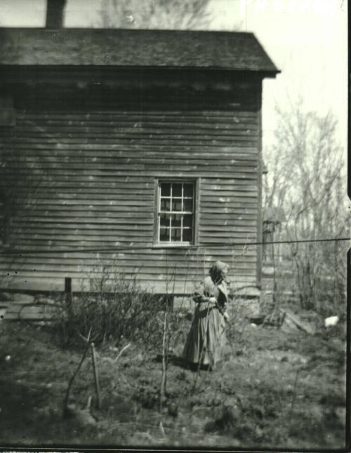 Woman in Front of House