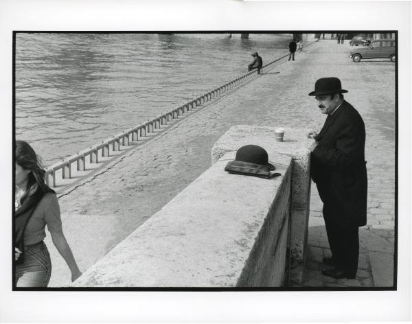 Man in hat watching river, Paris, 1977